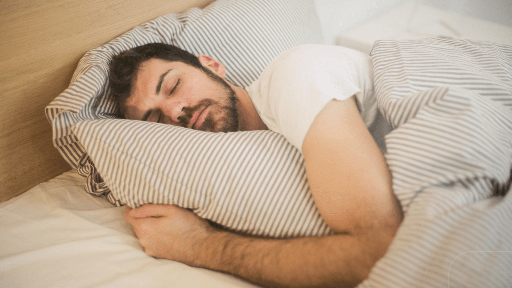 man sleeping in white bed