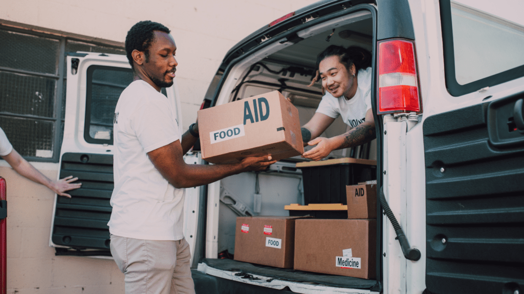 Two men carrying box