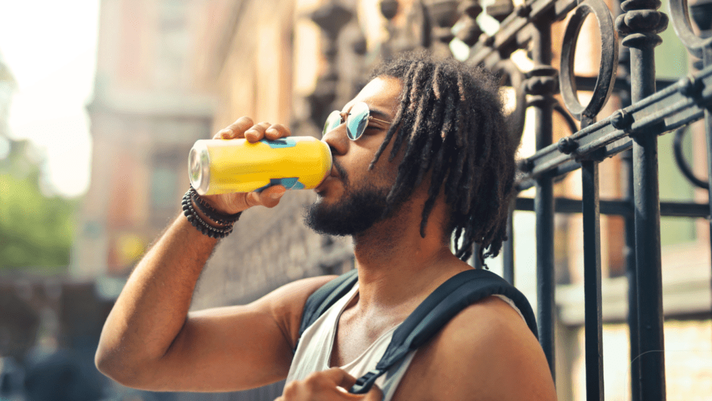 man drinking in can