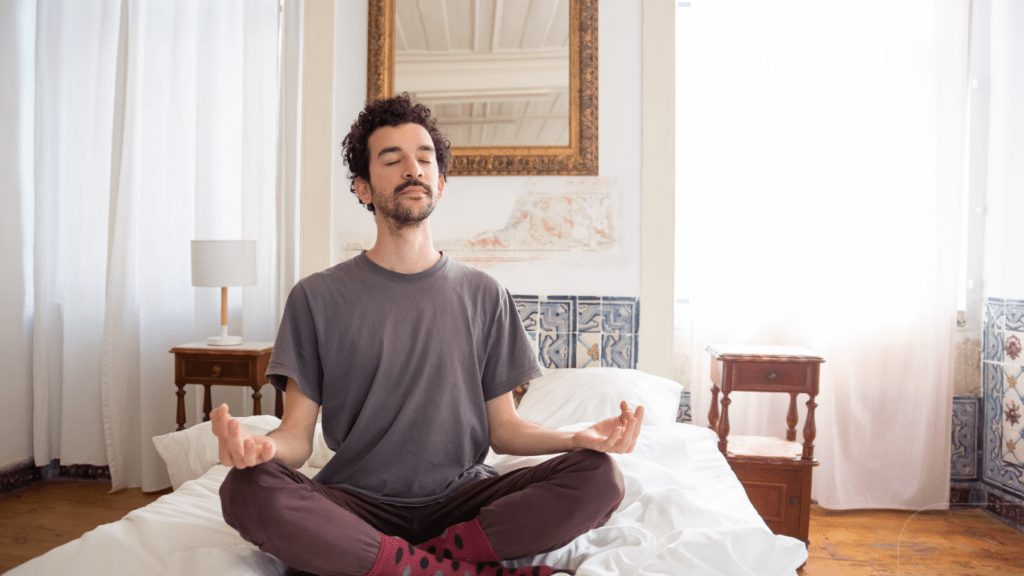 man meditating in the bed