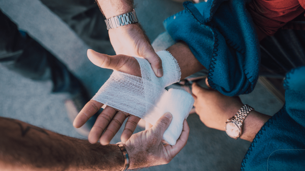 man wrapping his hand with bandage