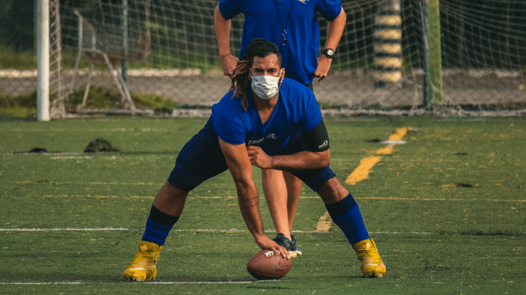 men in blue shirt practicing football