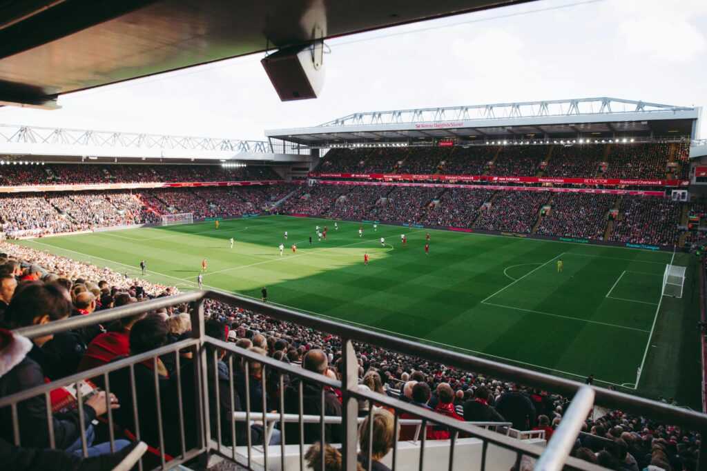 A vibrant soccer game with a full crowd in a modern stadium, capturing the energy of the sport.